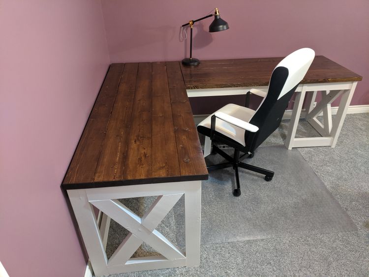 A picture of an L-shaped office desk with white chair.